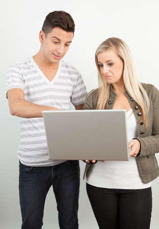 Students using a laptop against a white backgroundの写真素材