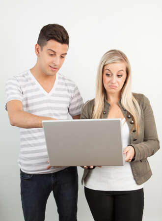 Students using a laptop against a white backgroundの写真素材