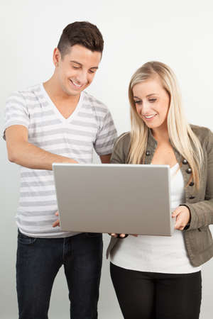 Students using a laptop against a white backgroundの写真素材