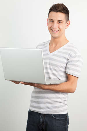 Young man posing against a white backgroundの写真素材