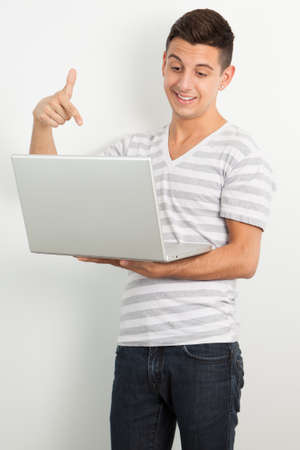 Young man posing against a white backgroundの写真素材