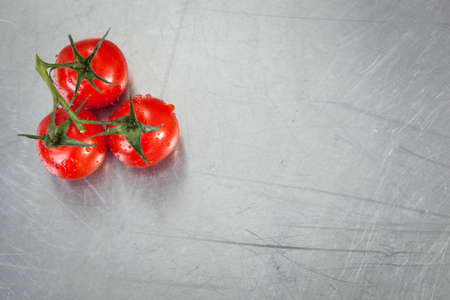 Cherry tomatoes on a stainless counterの写真素材