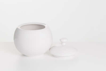 White ceramic sugar-bowl on a white backgroundの写真素材