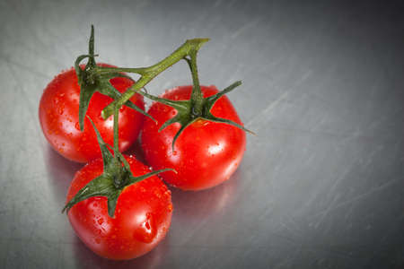 Cherry tomatoes on a stainless counterの写真素材
