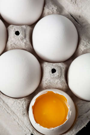 One cracked egg in cardboard  containerの写真素材