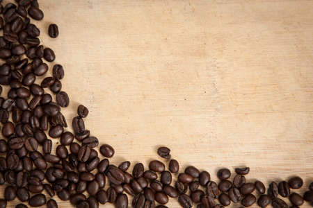 Coffee beans on a wood plankの写真素材