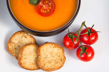 Tomato soup with bread and tomatoes close-upの写真素材