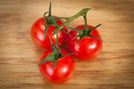 Cherry tomatoes on a wood counterの写真素材