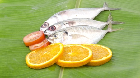 Fresh fish decorated and stacked on banana leaf.の写真素材