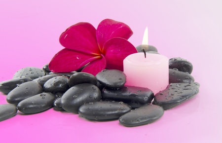 Spa concept with zen stones, candle and fragipani flower の写真素材