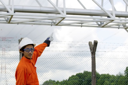 Engineer pointing to structural steel pipeline の写真素材
