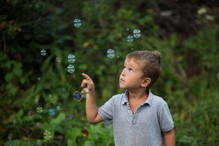 litlle boy playing with bubble outdoor at eveningの写真素材