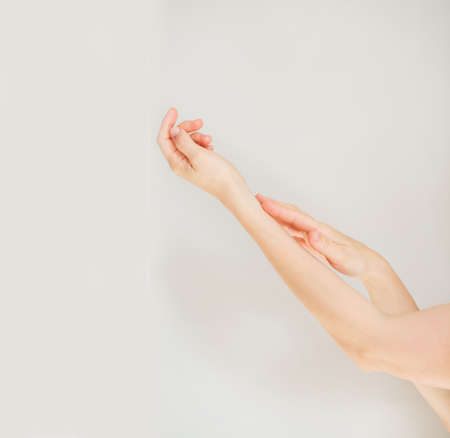 Two European womans hands touching each other