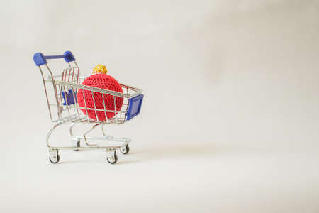 Christmas kni ornament in shopping cart. Christmas minimalism conceptの写真素材