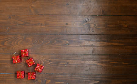 Little red gifts on dark wooden background
