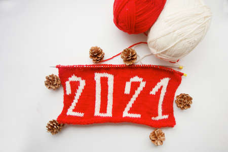 2021 Happy New Year. Knitted number. Skeins of yarn and pine cone.の写真素材