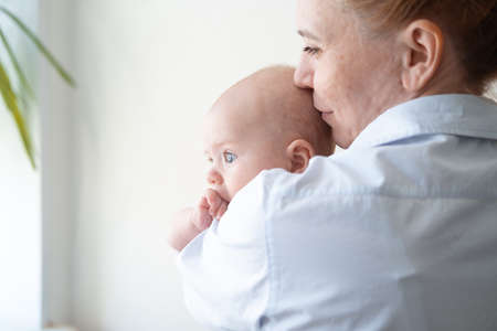 Attractive happy mother hold kiss with little baby boy. Endless love. Happy family