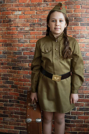 Little girl in military uniform at the May 9 celebration in Russia, Victory Day.の写真素材