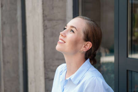 happy confident business woman, dream, sit in cityの写真素材