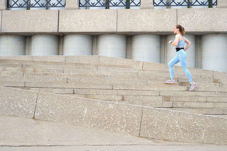 Young fitness woman running in the cityの写真素材