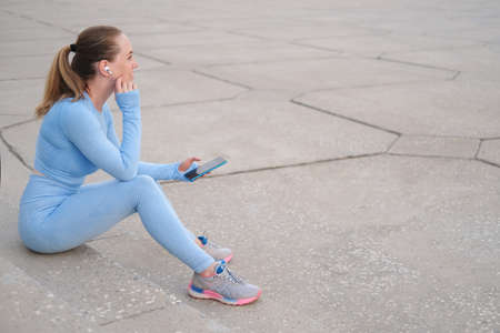 Young fitness woman finish running in the cityの写真素材