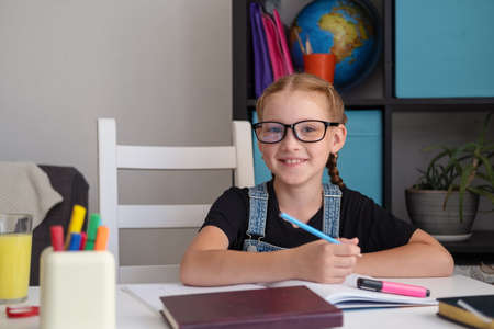 cute happy caucasian redhead girl studying at homeの写真素材
