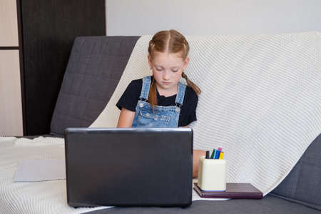 caucasian redhead girl using laptop studying at homeの写真素材