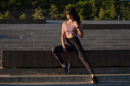 Young fitness woman finish run, listen musicの写真素材