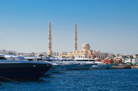 boats in port next to the fishing market and Central Mosque on the background, Hurghada, Egyptのeditorial素材
