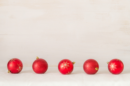 A row of Christmas balls on light wooden backgroundの写真素材