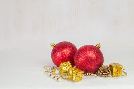 Christmas decorative red balls on light wooden backgroundの写真素材
