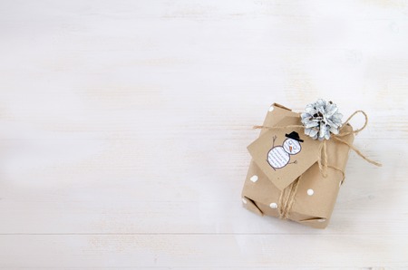 Different Christmas presents with handmade decoration on wooden backgroundの写真素材