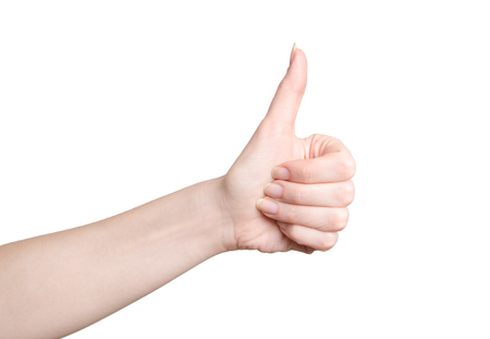 female teen hand shows thumbs up, isolated on whiteの写真素材