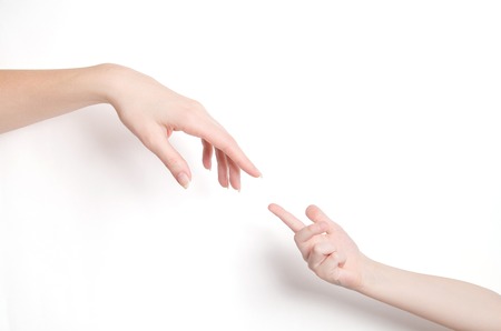 childs's hand and adult's hand on white backgroundの写真素材