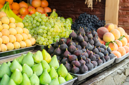 Figs, grapes, banana, peaches fresh fruits are at a marketの写真素材