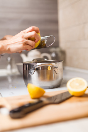 making custard on home kitchen with lemon juiceの写真素材
