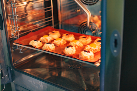 Butter baking in the open professional oven on the red silicone coverの写真素材