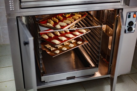 Butter baking in the open professional oven on the red silicone coverの写真素材