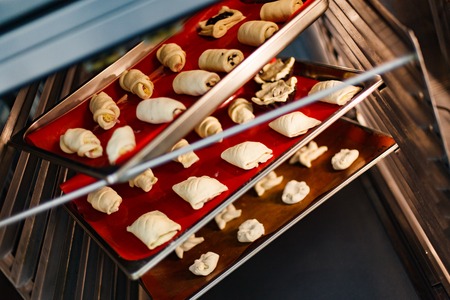 Butter baking in the open professional oven on the red silicone coverの写真素材