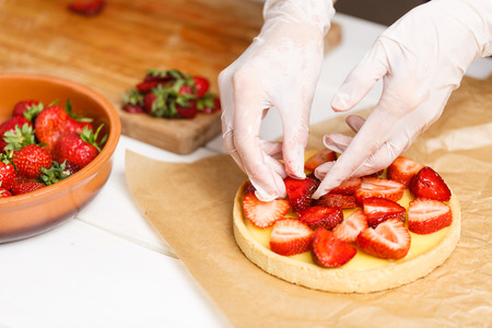 homemade preparing strawberry tart on white wooden deskの写真素材