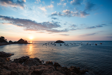 View of the sea and sunrise from the cliff in Tossa del Marの写真素材