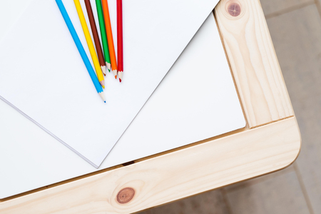 group of multicolored pencils lying on a white tableの写真素材