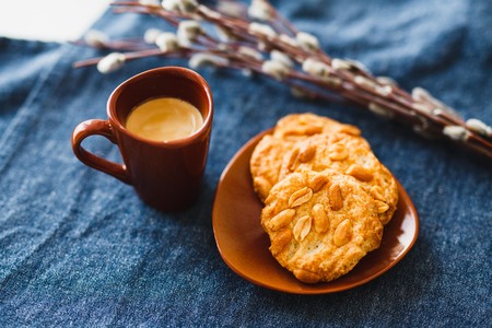 A cup of espresso on a table with cookies in a saucerの写真素材