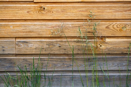 Fragment of an old wooden house with a protruding stickの写真素材