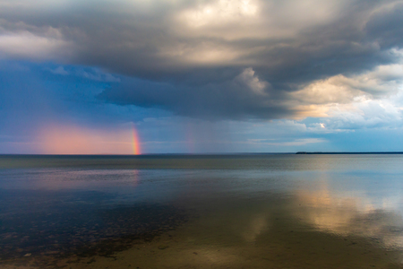 Lake Naroch. landscape. rain and sun. rainbow over the waterの写真素材