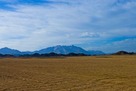 Desert, waves, golden sand and sky.の写真素材