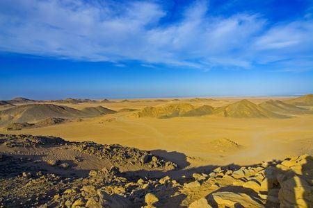 Desert, waves, golden sand and sky.の写真素材
