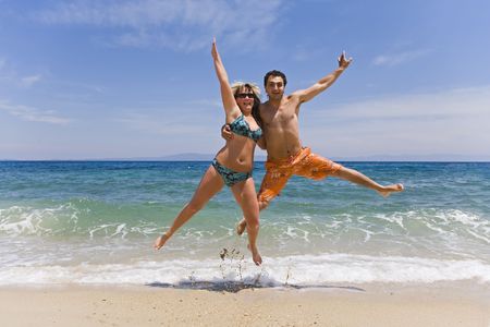 Young people jump on seacoast の写真素材