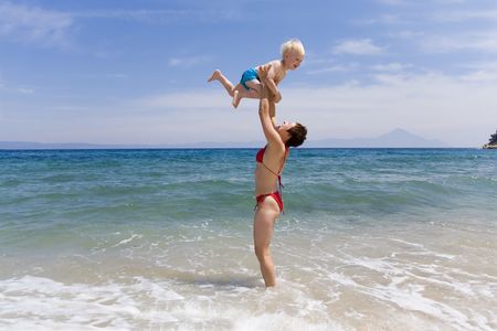 Ma with child on beachの写真素材