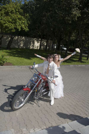 Bride and groom on a motorcycleの写真素材